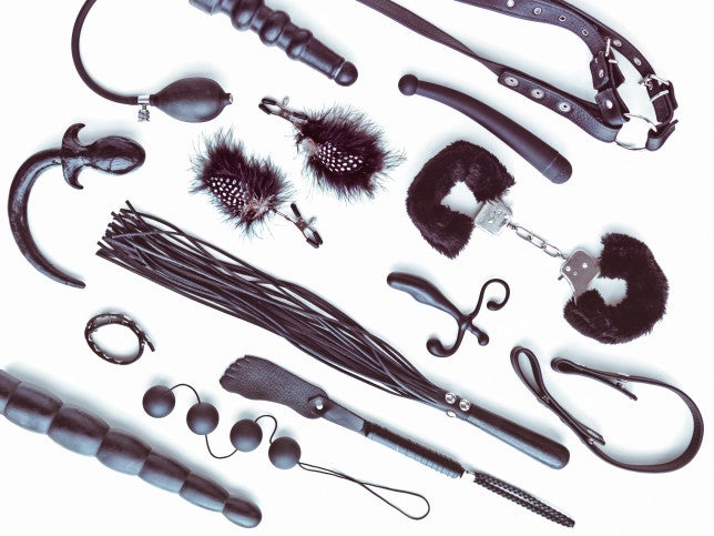 Directly Above Shot Of Various Sex Toys Over White Background
